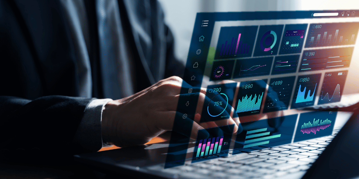 Professional reviewing data analytics and performance dashboards on a laptop.