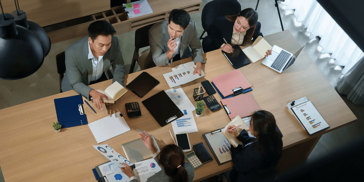 Business team reviewing charts and performance data together during a meeting.